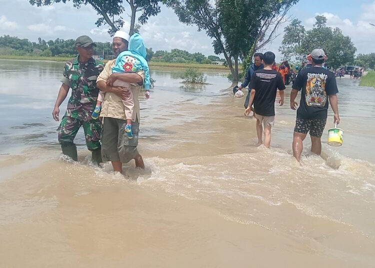 Babinsa Bantu Proses Evakuasi Warga Terdampak Banjir di Balongpanggang